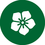 A white flower icon on a dark green background circle