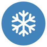 A white snowflake on a blue background circle